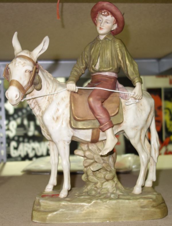 A Royal Dux porcelain figure of a boy riding a donkey.  CAB