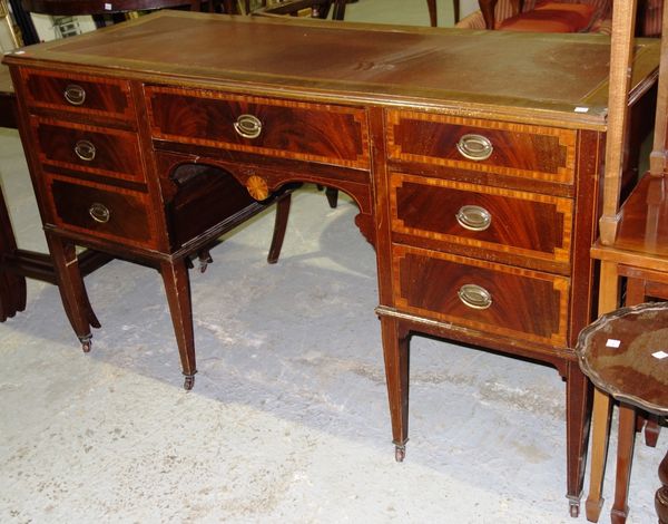 An Edwardian mahogany and satinwood banded kneehole desk, 134cm wide.  G2