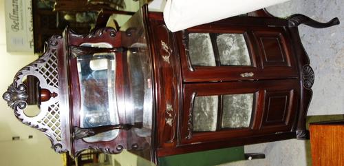 A 19th century walnut bowfront music cabinet with pair of glazed doors and mirrored back, 61cm wide.  H3