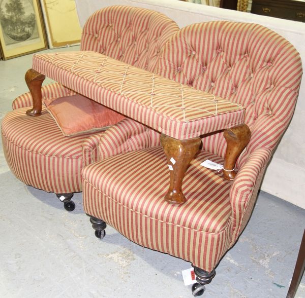 A 19th century gold and red striped upholstered nursing chair together with another similar and a long foot stool, (3).  E2
