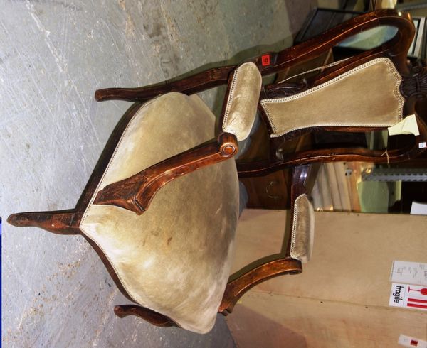 An Edwardian walnut upholstered open armchair.   F7