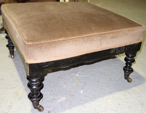 A Victorian ebonised framed footstool, 66cm wide.