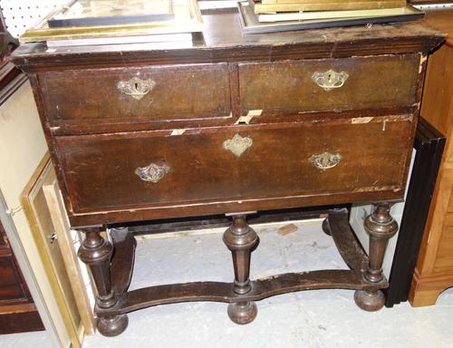 A 17th century style oak chest of two short and one long drawer, 96cm wide.