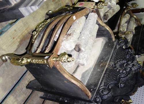A serpentine steel iron and brass fire basket. DISPLAY