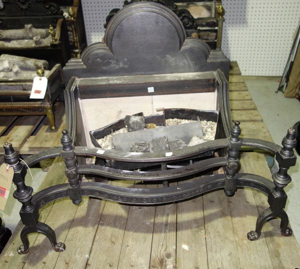 A large cast iron fire basket with outswept supports and arched back.  DISPLAY