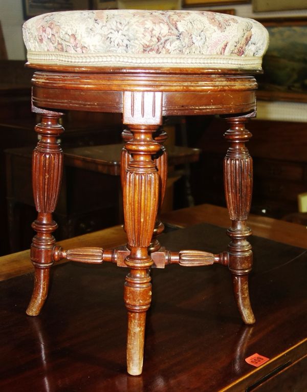 A 19th century oak circular piano stool.   I2