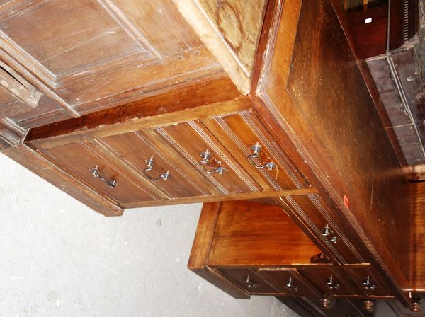 An Edwardian walnut kneehole desk.   DIS