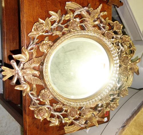 A 20th century gilt wall mirror moulded with flora and fauna, 52cm x 71cm. A3