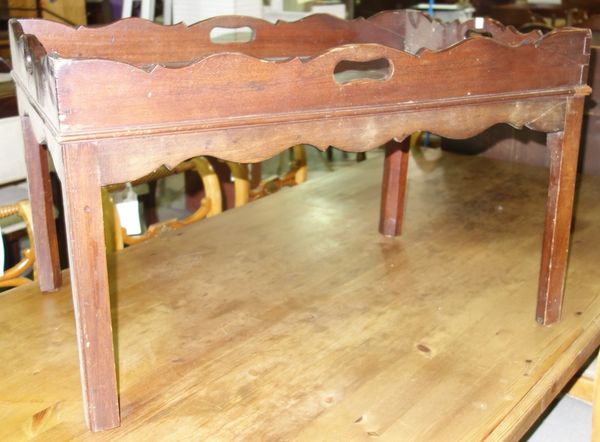 A 20th century mahogany tray top coffee table.  E5