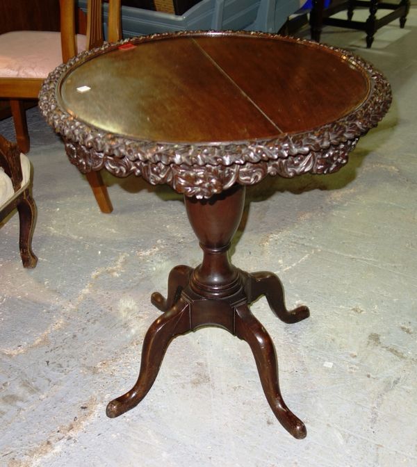 A mahogany circular occasional table with carved rim.  F7