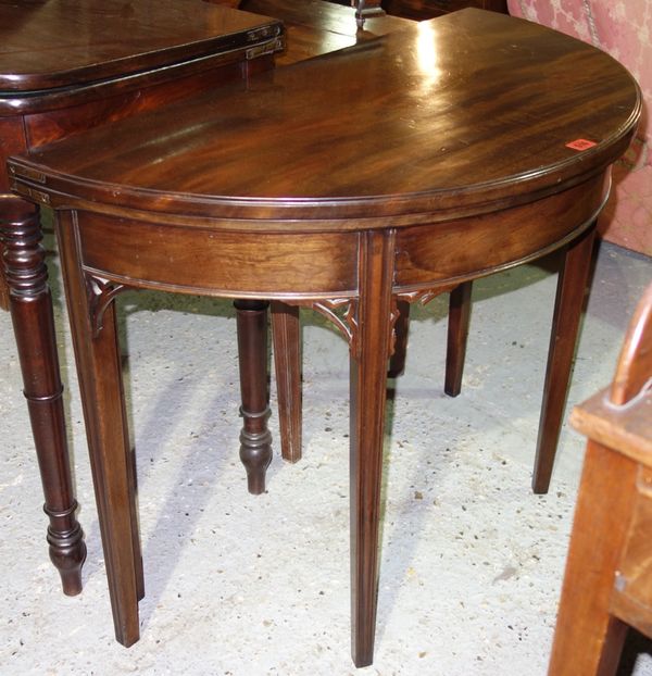 An 18th century mahogany card table on tapering square supports, 93cm wide.  I5