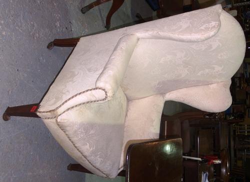 A 19th century mahogany framed wing back upholstered armchair.  C7