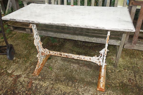 A cast iron marble top rectangular table.  OUT