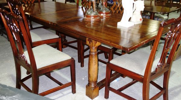 A 20th century oak extending dining table with one extra leaf.  E6