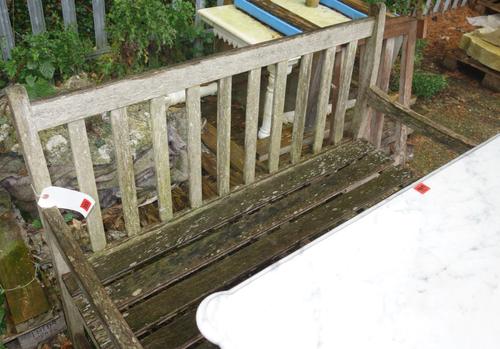 A 20th century teak garden bench.   OUT