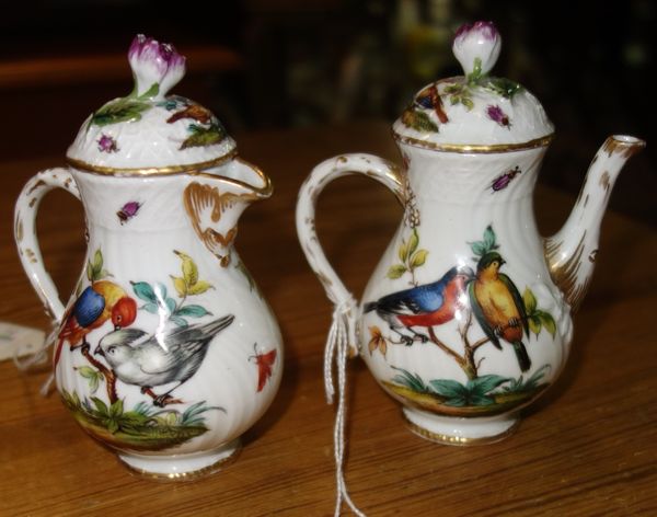 A Dresden porcelain sparrow beak jug and cover, late 19th century, painted with wild birds and with 'AR' to the base, 11.5cm high, and a matching jug