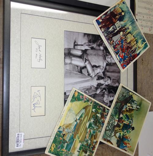 A framed photo of Dorothy, Tinman and Scarecrow from 'Wizard Of Oz', signed by the Scarecrow and Tinman actors, together with three lobby cards. (4)Al