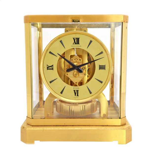 A Jaeger Le Coultre brass cased Atmos clock, late 20th century, serial number 563996, on a canted rectangular plinth, 23.5cm high.  Illustrated