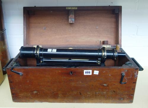 A Casella ten inch spirit level, lacquered brass, with accessories, in a mahogany fitted case, and a Casella copper rain measuring gauge with glass cy