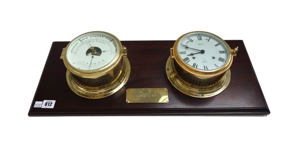A modern brass ship's clock and matching barometer, mounted on a mahogany plinth with applied 'Engine Room' brass plaque, 61cm wide, (key).