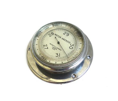 A Negretti and Zambra motor aneroid , circa 1920, the nickel plated dial with scale from 27-31 millibars, the rotating outer ring dial with ascent and