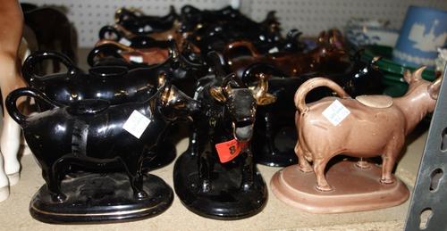 A quantity of brown and black glaze Jackfield type 19th century cow creamers, (qty). S2T