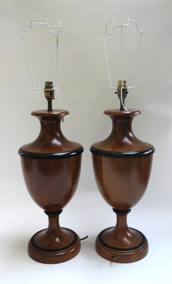 A pair of modern fruitwood table lamps, each of urn form with ebonised banding, on a circular foot, with pleated shades, 46cm high excluding fitments
