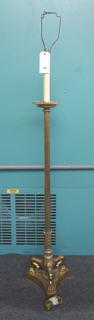 A gilt brass Empire style standard lamp, 20th century, with fluted column and triform lions paw base, 125cm high excluding fitments.