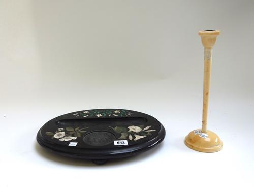 A pietra dura oval desk stand, 19th century, of oval form, inlaid with flowers, on four bun feet, 35cm wide, and a 19th century turned ivory candlesti