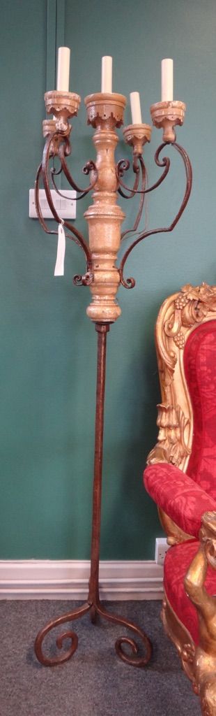 A pair of wrought iron and painted timber five light standing candelabra, possibly Italian or Spanish, fitted for electricity, 165cm high excluding el