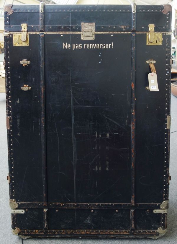 Two ebonised wooden bound travelling trunks, mid 20th century, each with applied plaque for 'Alfred Hablutzel Sohne', the hinged lid and removable fro