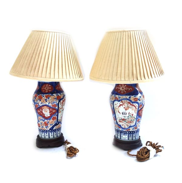 A pair of Japanese porcelain vases, late 19th century, each imari decorated and later converted to table lamps, with pleated shades, the vases 25cm hi
