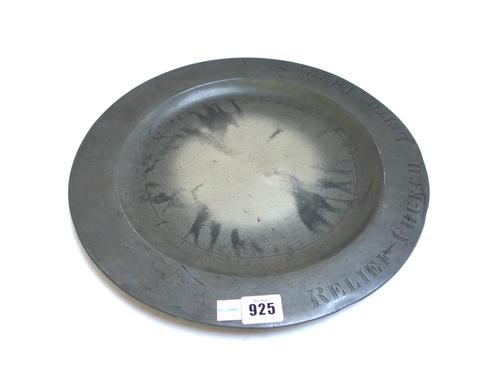 A quantity of 18th and 19th century pewter dishes and plates, including two embossed with crests, together with a foliate wriggle work plate, 22.5cm d