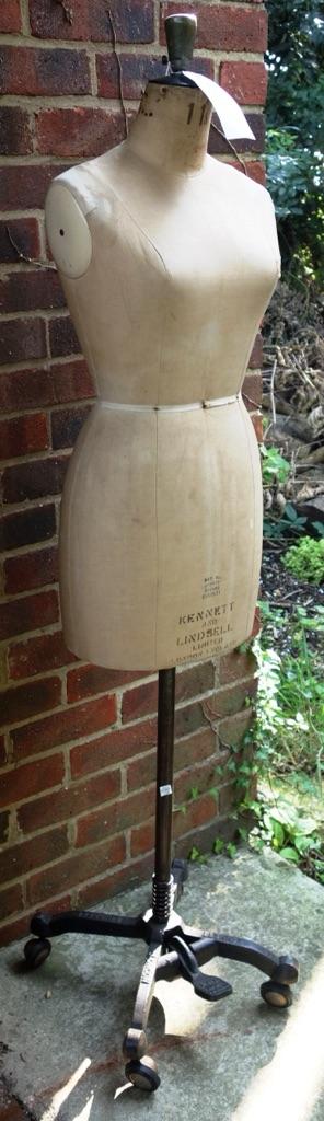 A dress maker's dummy, late 19th/early 20th century, by Kennett and Lindsell Ltd, London, the upholstered torso raised on a cast iron frame and four w