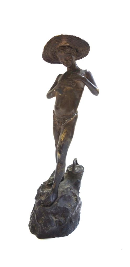 A 19th century patinated bronze figure of a young boy holding a fish, indistinctly signed, on a naturalistic rocky base, 38cm high.