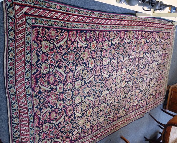 A Senneh gelim, Persian, the black field with an allover herate design, three minor borders, 300cm x 174cm.