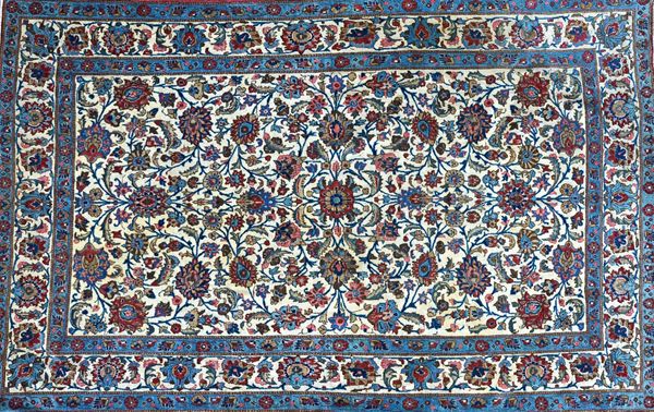 An Esfahan rug, Persian, the ivory field with an allover floral design of palmettes, rosettes and leaf vines, a complementary ivory border, 218cm x 13