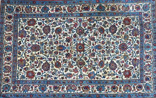 An Esfahan rug, Persian, the ivory field with an allover floral design of palmettes, rosettes and leaf vines, a complementary ivory border, 218cm x 13