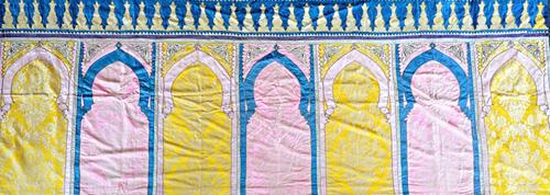 A Moroccan brocaded velvet multiple prayer saph, early 20th century, each panel with coloured silk applique borders and decoration, 380cm x 140cm.  Il