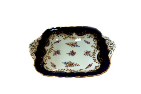A Coalport dessert service for twelve, early 20th century, with printed and coloured flowers within a cobalt blue border, comprising; twelve plates, 2