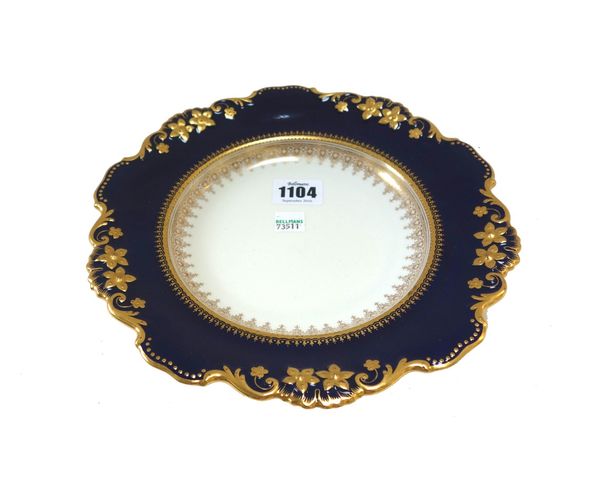 A Spode dessert service for twelve, early 20th century, decorated with relief cast gilt flowers within a wide shaped cobalt blue border, comprising; t