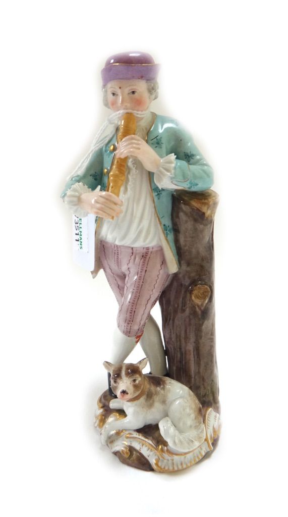 A Meissen porcelain figure, late 19th century, modelled as a piper leaning against a tree trunk with a dog at his feet, on a gilt scroll base, with bl