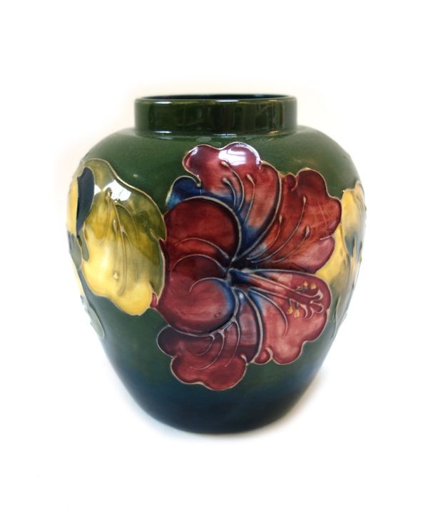A group of Moorcroft pottery, circa 1930 and later, green and cream grounds decorated with flowers, with two ginger jars (one lacking a cover), two sm