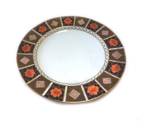 A Royal Crown Derby matched part dinner service, early 20th century, decorated in a gilt Imari pattern, comprising; two graduated oval platters, 43cm