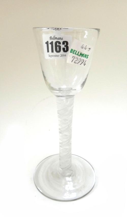 An opaque twist wine glass, circa 1765, with rounded funnel bowl and circular foot, 15cm high.