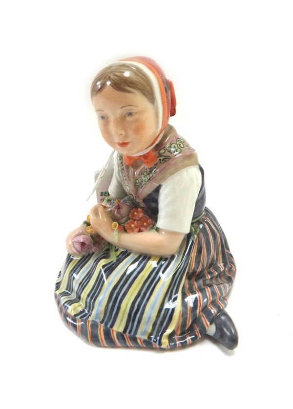 A Copenhagen porcelain figure, Slesvig Girl, model no.12417, modelled as a Danish girl with flowers, 9cm high.