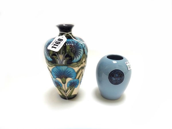 A Moorcroft pottery vase by Rachel Bishop, circa 2013, decorated with blue flowers against a cream ground, 15.5cm high, together with one further smal