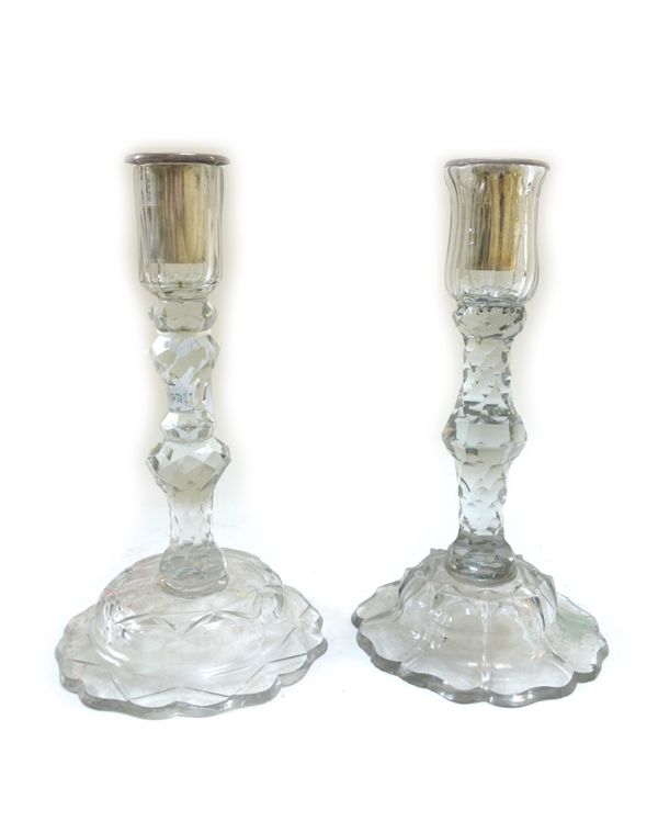 A pair of cut glass candlesticks, late 18th/19th century, with faceted knopped stems, each on a domed shaped foot (23cm high) and three further simila