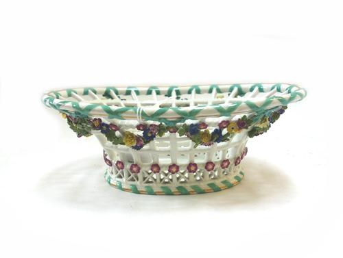 Six Meissen reticulated baskets, circa 1770, blue crossed swords and dot marks, applied with flowers comprising; two oval baskets with flared rim and