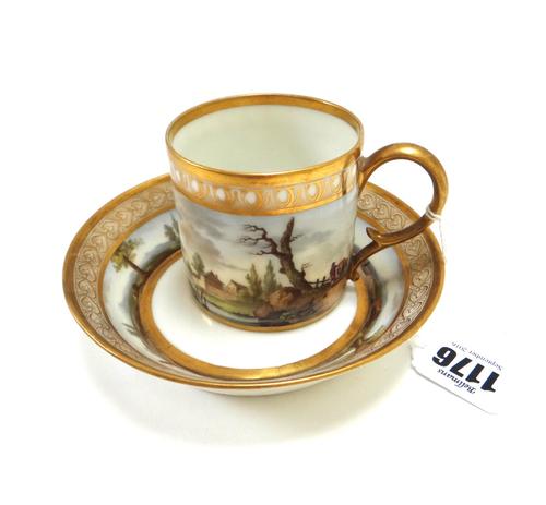 A Paris porcelain cabinet cup and a saucer, early 19th century, by Dihl and Guérhard,  painted with sheep grazing against a landscape within wide gilt